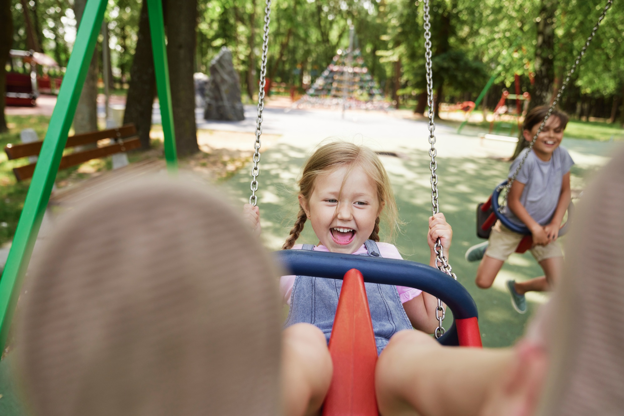 Cute little girl have fun at the swing set