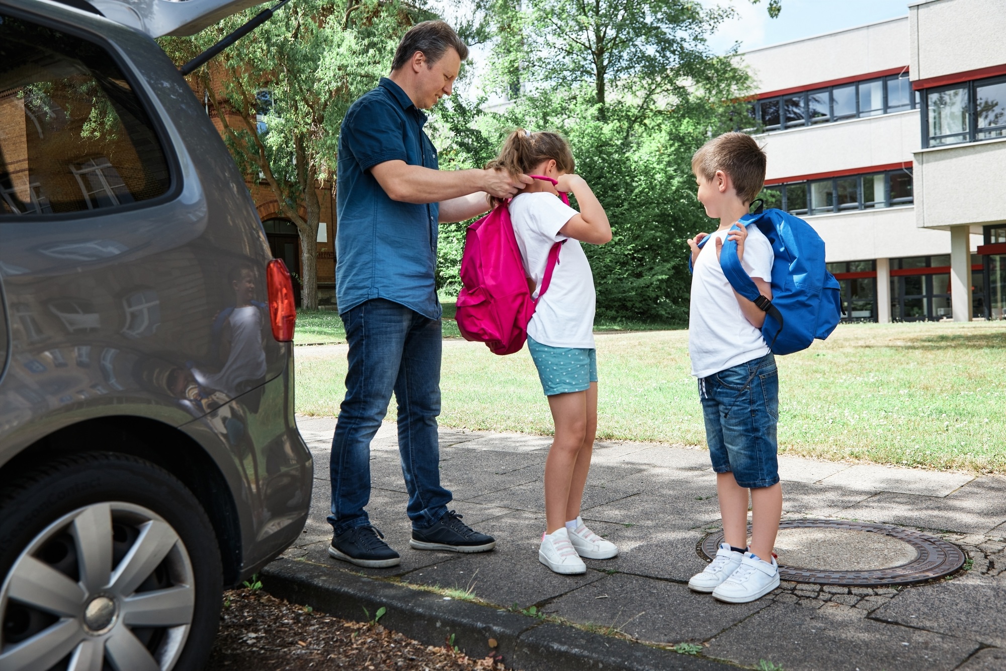 Dad accompanies children to school
