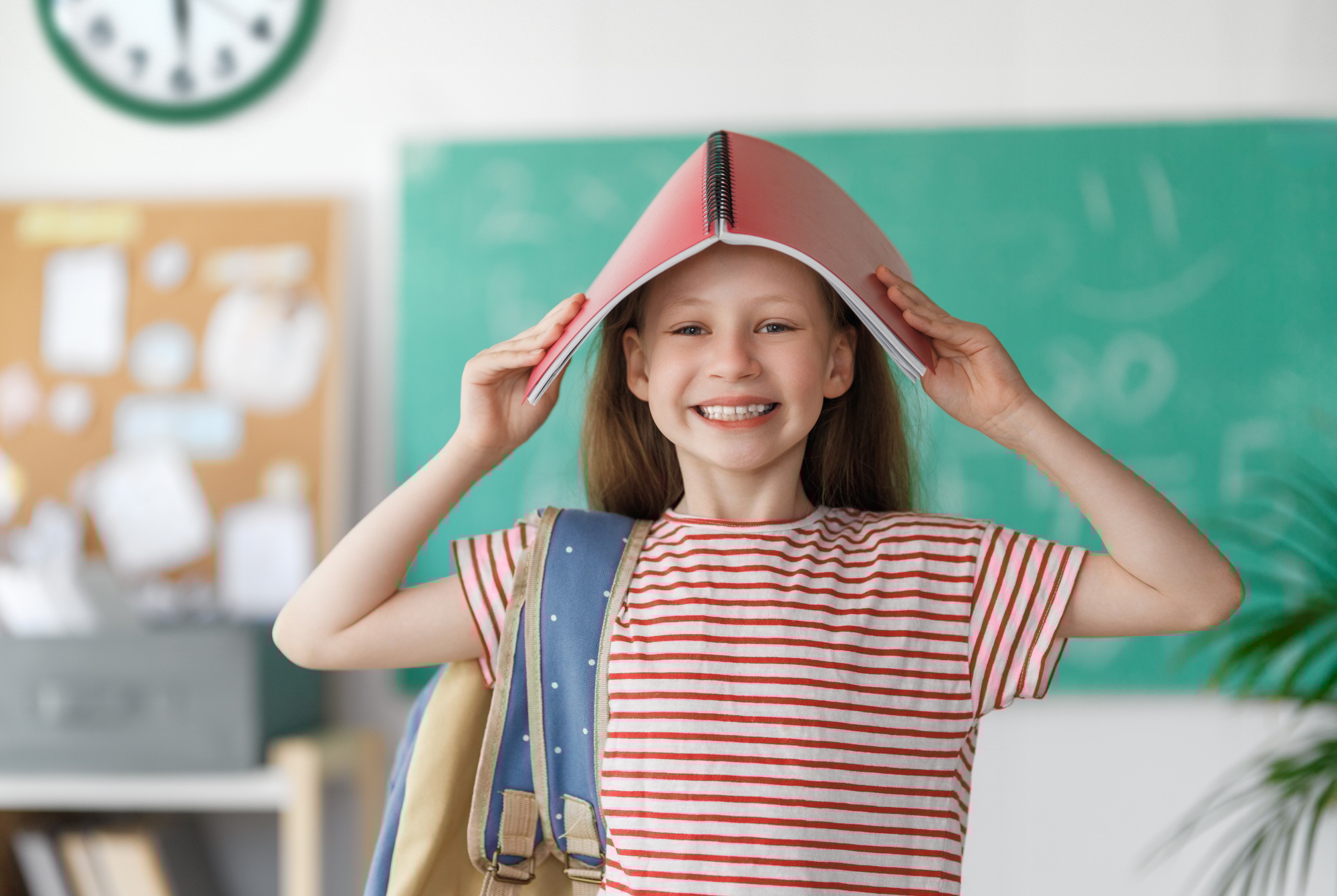 Girl with backpack indoors