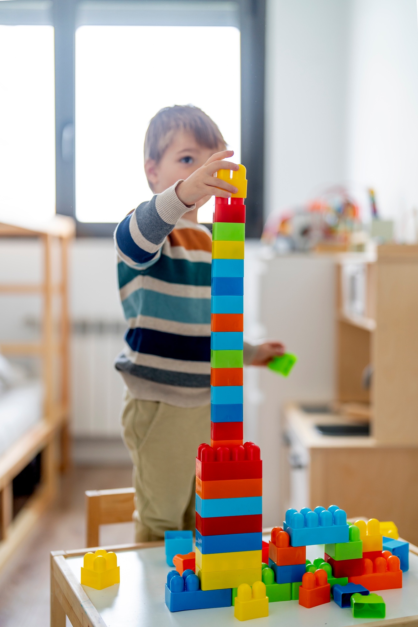 Happy child at home playing with removable parts