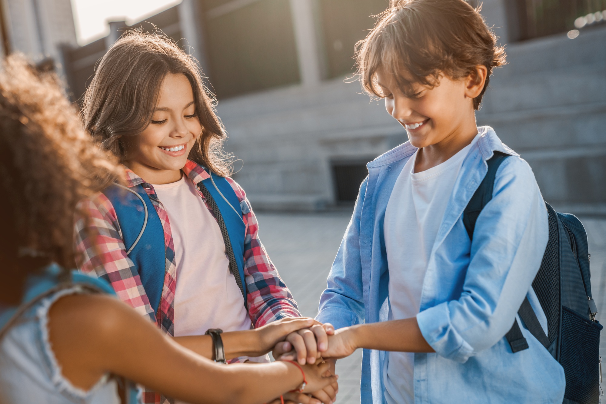 School kids are holding hands together at the yard